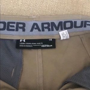 Khaki Under Armour golf shorts.